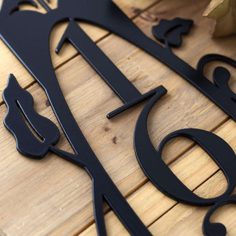Close up of vines and house number on our 4 digit vertical metal house number sign, in matte black powder coat.