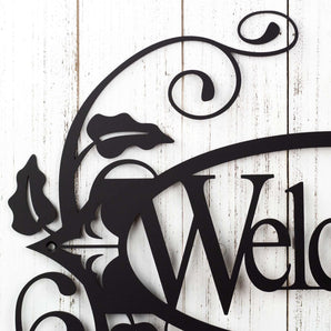 Close up of vines and fleur de lis on our oval welcome metal wall art, in matte black powder coat. 