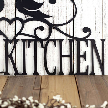 Close up of kitchen word on our custom metal sign, in matte black powder coat. 