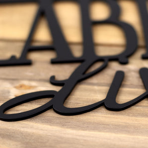 Close up of matte black powder coat on our Labradors Live Here metal sign. 