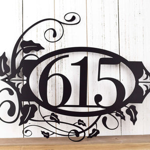 Custom oval metal house number plaque with fleur de lis and vines, in matte black powder coat. 