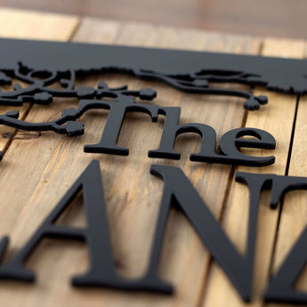 Close up of matte black powder coat on our cherry tree metal family name sign.