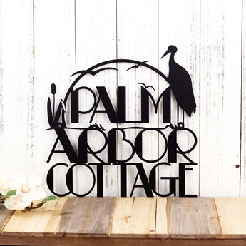 Modern metal house name sign with heron and cattails lake scene, in matte black powder coat.