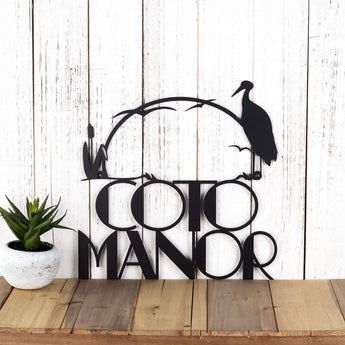 Personalized metal heron and cattails house sign with modern font, in matte black powder coat. 