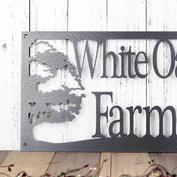 Close up of farm name on our rectangular oak trees custom metal sign, in silver vein powder coat.
