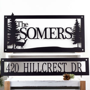 Personalized rectangular family name and address sign, in matte black powder coat. Includes a doe deer and pine trees.