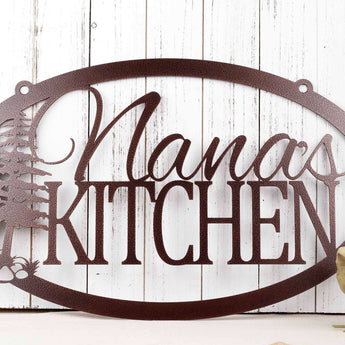 Oval personalized kitchen name metal sign with pine trees, in copper vein powder coat.
