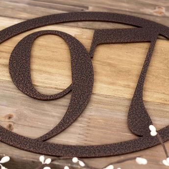 Close up of house number on our 2 digit oval address plaque, in copper vein powder coat. 