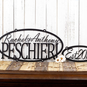 Oval sign with first names and family last name, along with an established year metal sign, in matte black powder coat.
