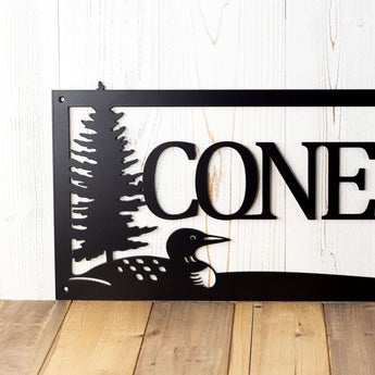Close up of loon bird on our custom family name sign, in matte black powder coat. 