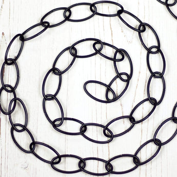 Black metal chain positioned in a spiral