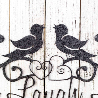 Close up of hearts and birds on our Live Laugh Love metal wall art, in silver vein powder coat.