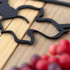 Close up of matte black powder coat on our Wine Time metal wall art.