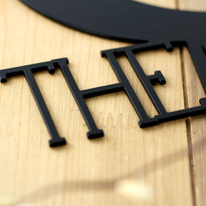 Close up of matte black powder coat on our Love You to the Moon and Back metal sign.