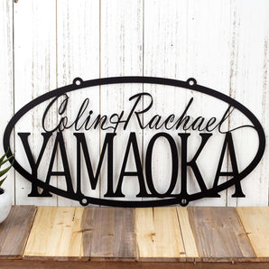 Personalized oval metal sign with first and last names, in matte black powder coat. 