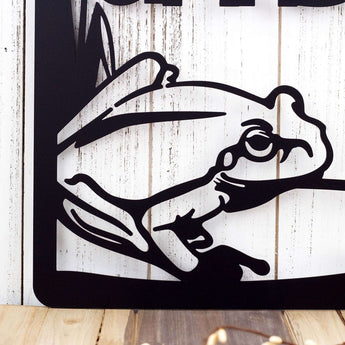 Close up of frog silhouette on our mom's garden hanging sign, in matte black powder coat.