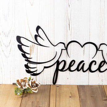 Close up of peace dove metal wall art, with a heart, in matte black powder coat.