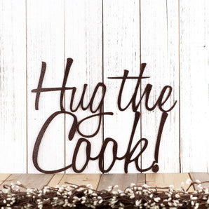 Hug the Cook! script metal wall art, in copper vein powder coat.