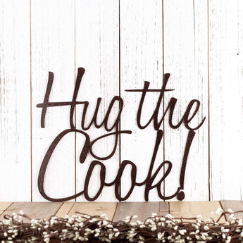 Hug the Cook! script metal wall art, in copper vein powder coat.