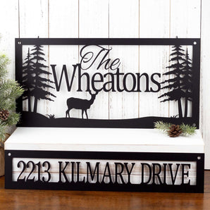 Personalized rectangular family name and address sign, in matte black powder coat. Includes a doe deer and pine trees.