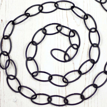 Black metal chain positioned in a spira.