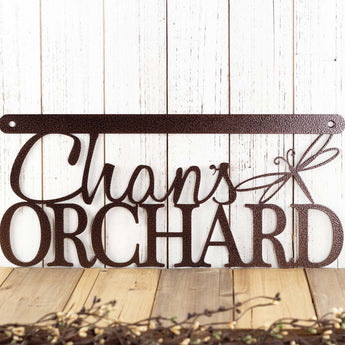Hanging orchard metal sign with first name and dragonfly, in copper vein powder coat.
