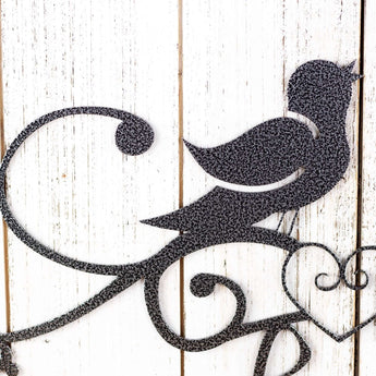 Close up of song bird on our Live Laugh Love metal sign, in silver vein powder coat.