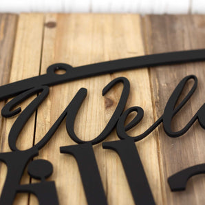 Close up of matte black powder coat on our Welcome to home name metal sign.
