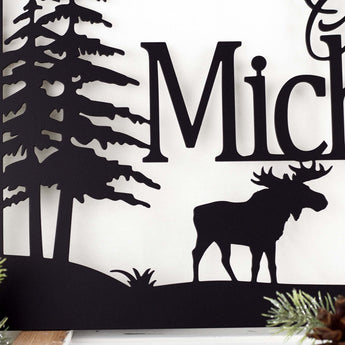 Close up of moose silhouette on our personalized metal family name plaque, in matte black powder coat.