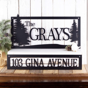 Personalized rectangular family name and address metal signs with pine trees, in matte black powder coat.