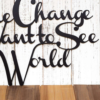 Close up of Be the Change you Want to See in the World metal wall decor, in matte black powder coat.