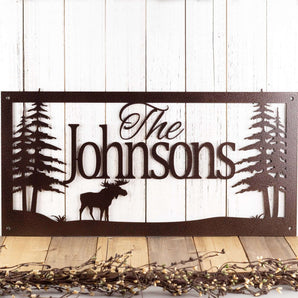 Rectangular personalized family name sign with moose and pine trees, in copper vein powder coat.