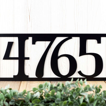 Close up of 4 digit rectangular metal house number sign, in matte black powder coat. 