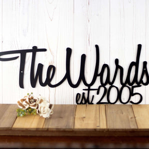 Custom family name and established year metal sign with script lettering, in matte black powder coat.