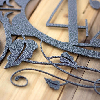 Close up of silver vein powder coat on our 4 digit metal house number sign with fleur de lis and vines.
