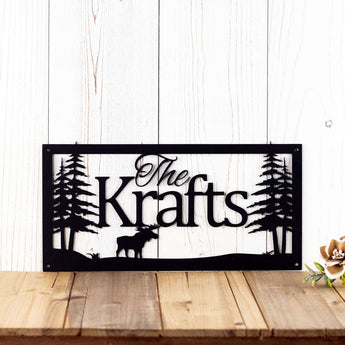Rectangular personalized family name sign with moose and pine trees, in matte black powder coat.