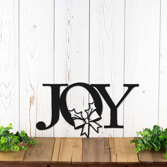 Joy metal word wall art with a Christmas wreath, in matte black powder coat.