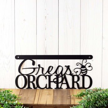 Hanging orchard metal sign with first name and dragonfly, in matte black powder coat.