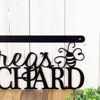 Close up of bumble bee silhouette on our metal orchard name sign, in matte black powder coat.