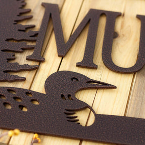 Close up of copper vein powder coat on our loon family name sign.