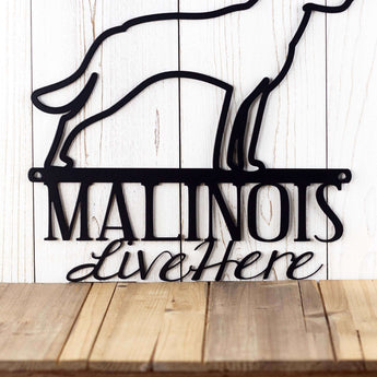 Close up of Malinois Live Here wording on our Malinois metal plaque, in matte black powder coat.