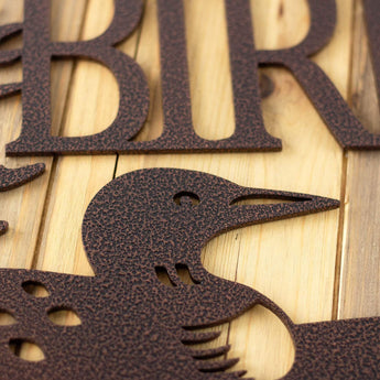 Close up of copper vein powder coat on our loon family name sign. 