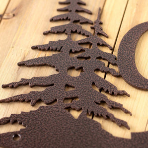 Close up of copper vein powder coat on our 2 digit metal house number sign with pine trees.