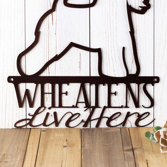 Close up of Wheatens Live Here wording on Wheaten metal sign, in copper vein powder coat.