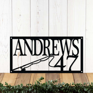 Rectangular family name and house number metal sign, in matte black powder coat. With fishing rod and reel