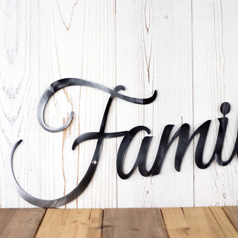 Close up of family script metal sign, in raw steel.