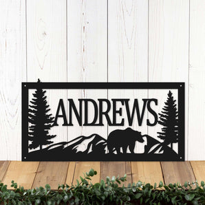 Rectangular metal family name sign with bear and mountains, in matte black powder coat.