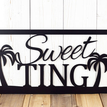 Close up of script lettering on our metal family name sign with palm trees, in matte black powder coat.