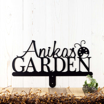 Garden name metal yard sign, with a ladybug silhouette, in matte black powder coat. 