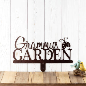 Garden name metal yard sign, with a ladybug silhouette, in copper vein powder coat. 